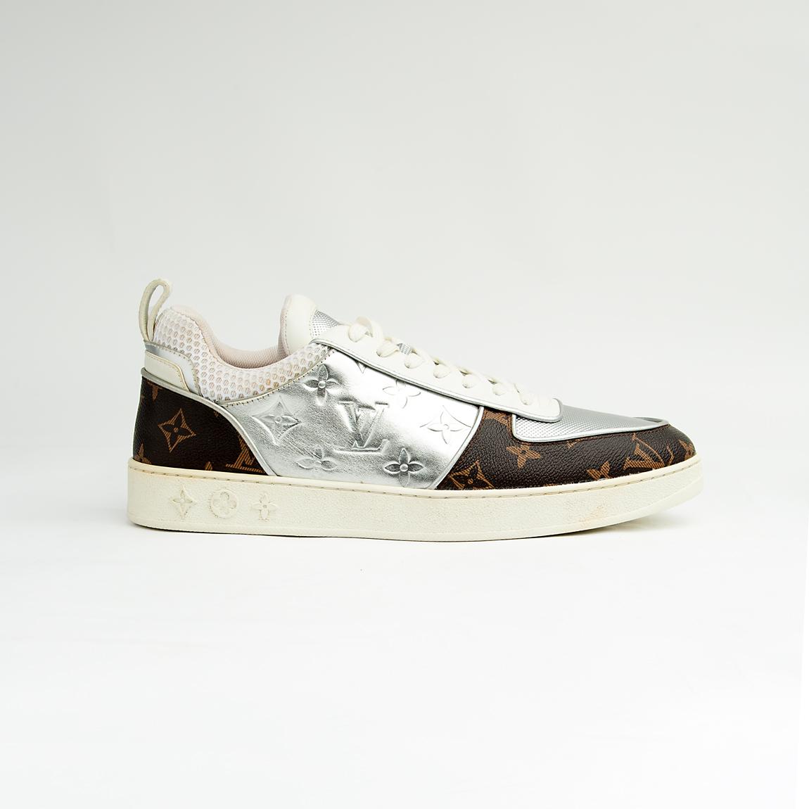 Dual-tone brown and silver unisex monogram embossed leather sneakers with classic design and comfortable sole.