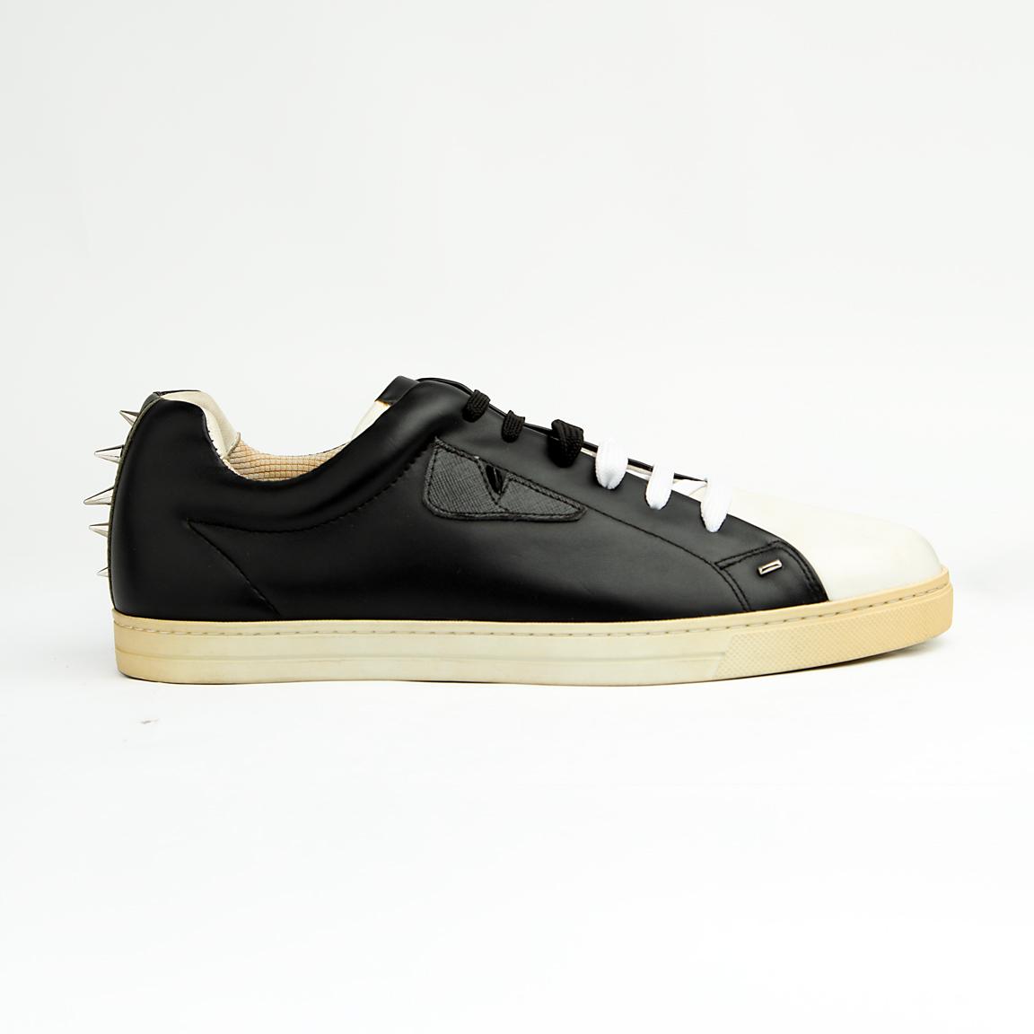 These sleek, premium leather sneakers perfectly blend classic low-top styling with the brand's signature playful-yet-edgy aesthetic.