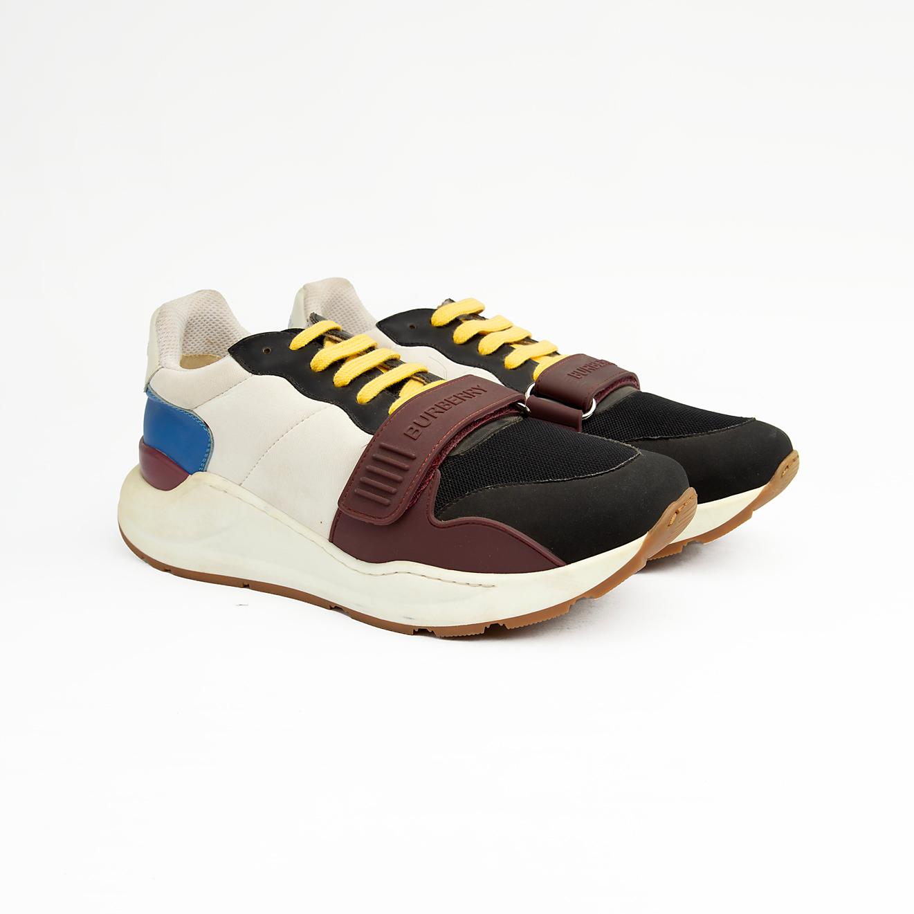 Stylish unisex multi-tone sneakers with adjustable strap, yellow laces, and cushioned sole — perfect for casual and streetwear looks.