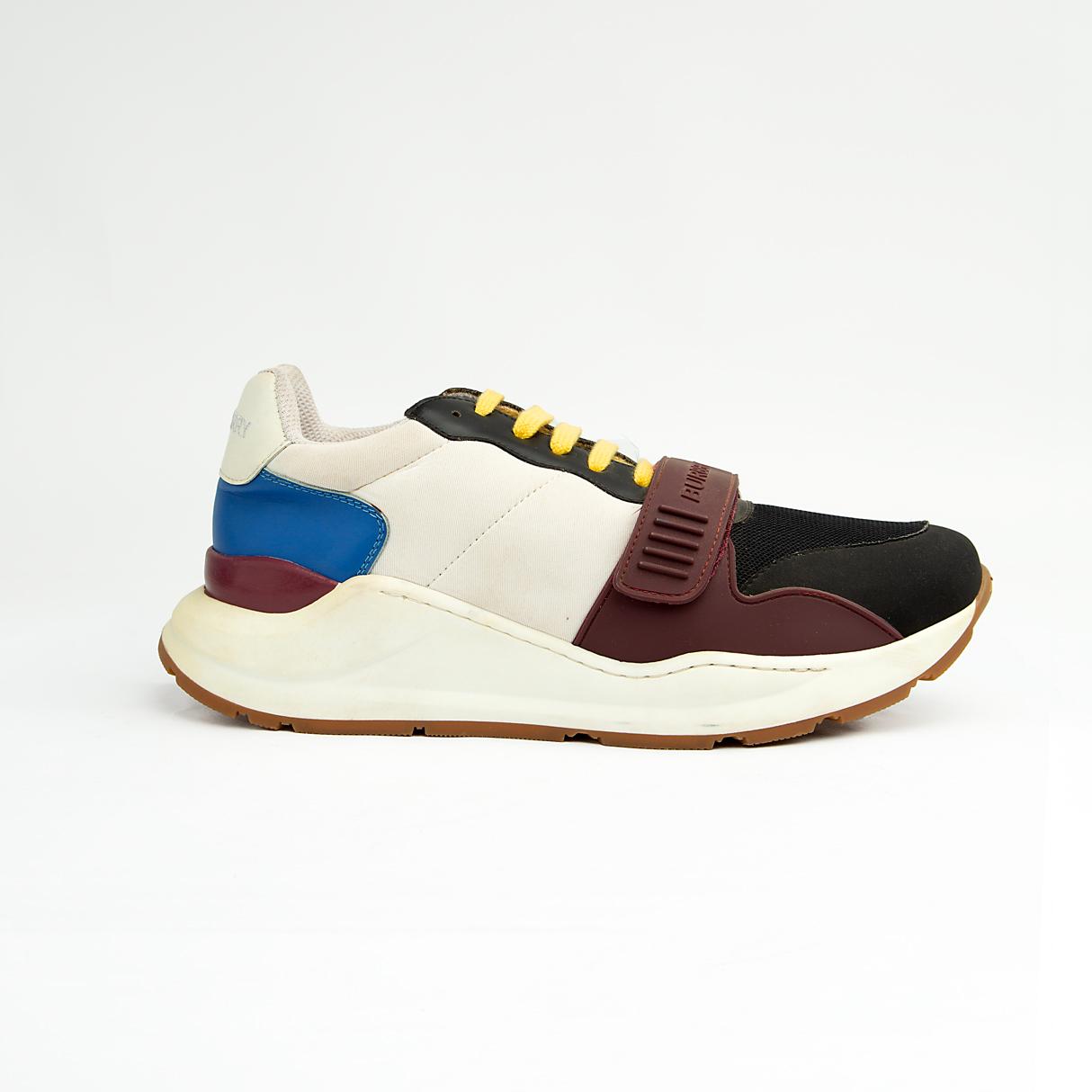 Stylish unisex multi-tone sneakers with adjustable strap, yellow laces, and cushioned sole — perfect for casual and streetwear looks.