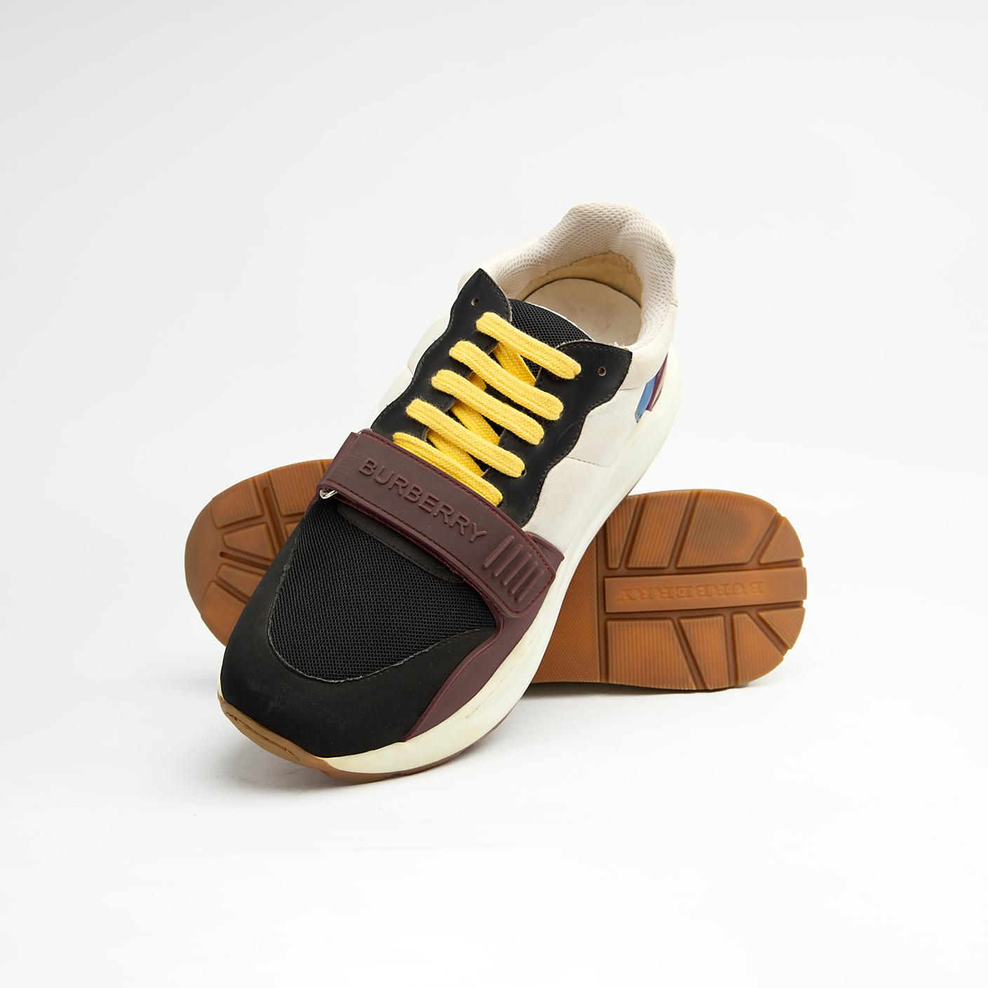 Stylish unisex multi-tone sneakers with adjustable strap, yellow laces, and cushioned sole — perfect for casual and streetwear looks.