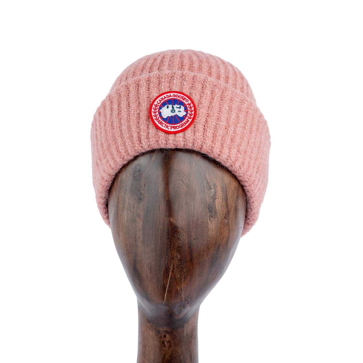 Pink ribbed knit beanie with Arctic Program logo patch, unisex winter hat.
