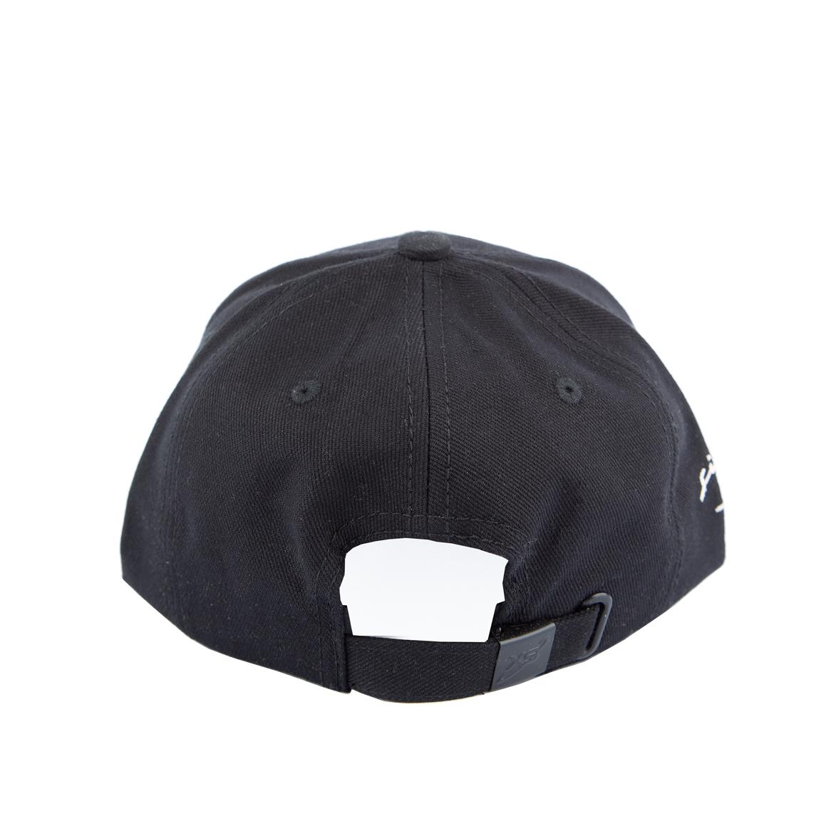 Black baseball cap with white signature embroidery on a plain background.