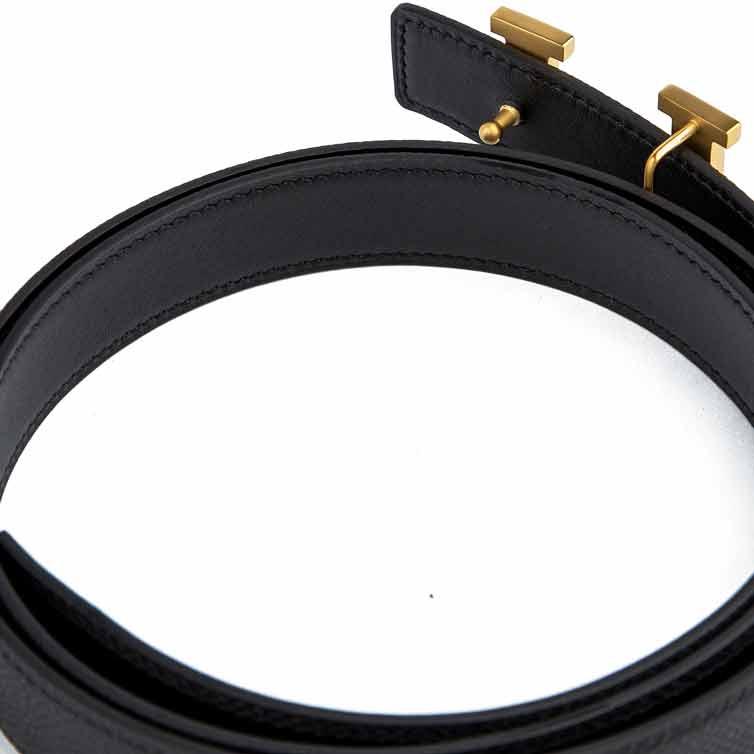 Black leather belt with gold H buckle.