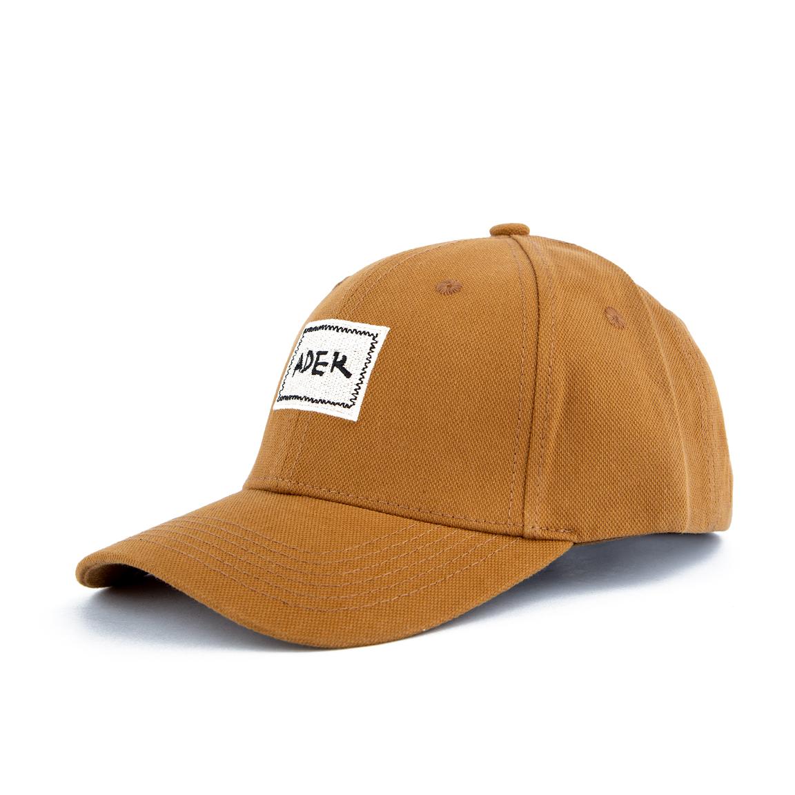Brown 'ADEK' embroidered cotton cap with an adjustable strap, unisex design, and modern streetwear vibe, perfect for all casual looks." Caption