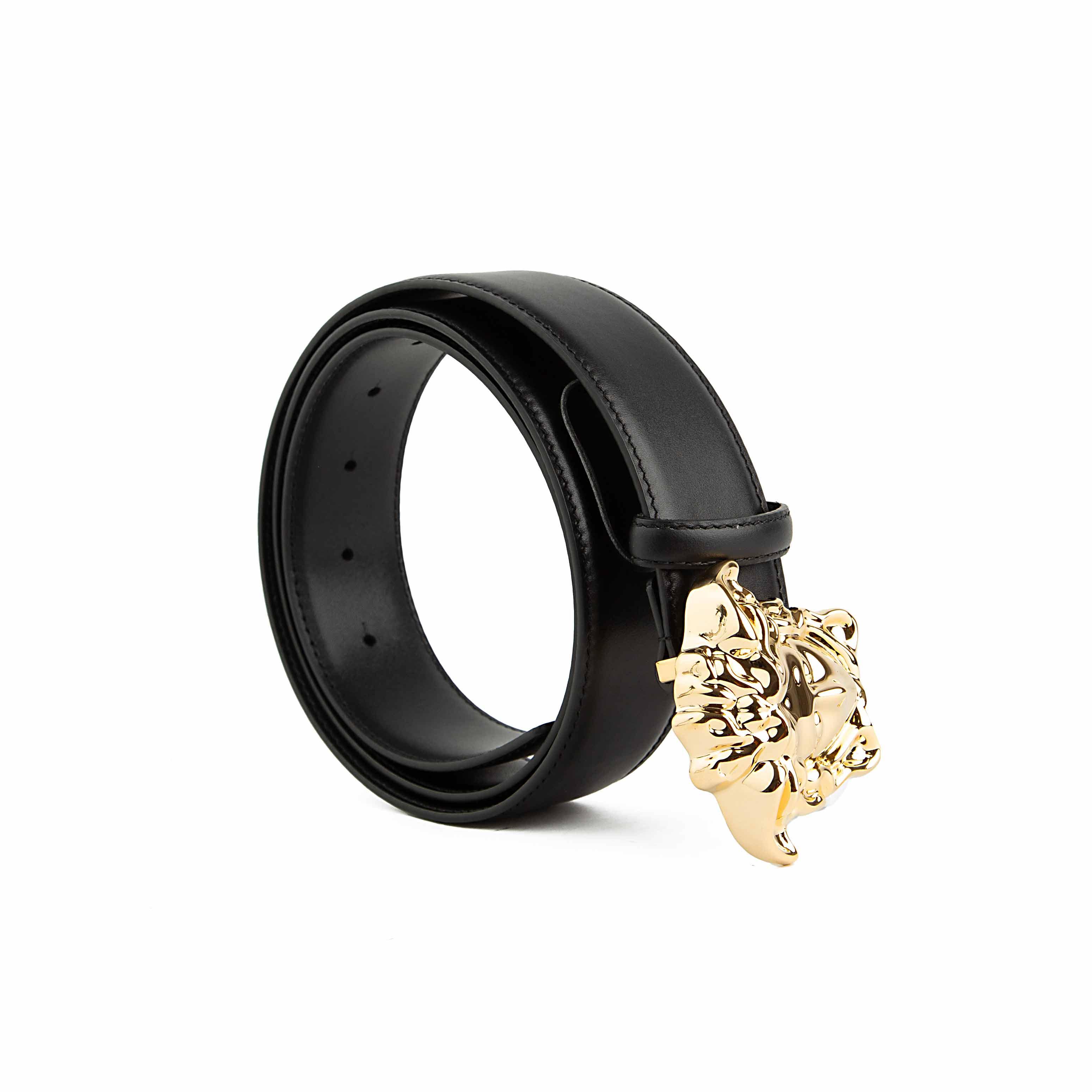 This accessory is a smooth black leather belt that serves as a bold statement piece.