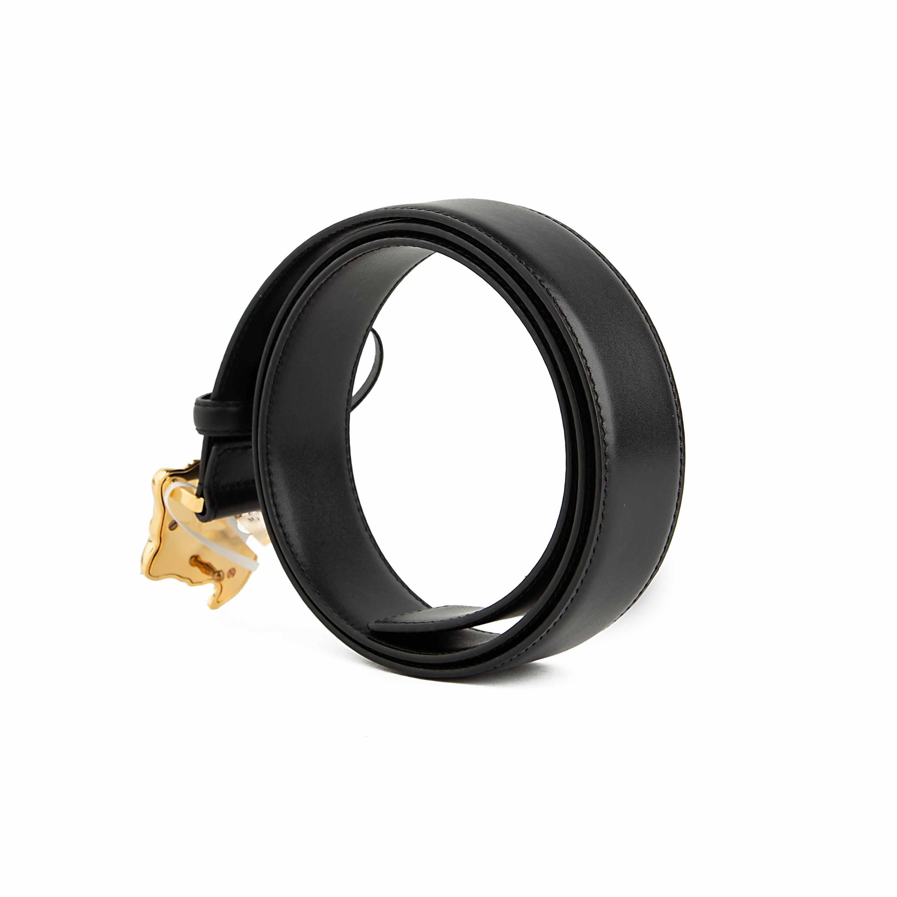 This accessory is a smooth black leather belt that serves as a bold statement piece.