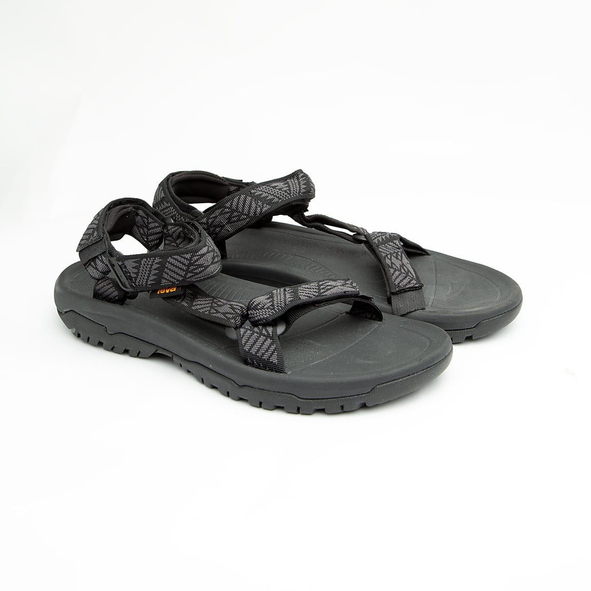 Black unisex outdoor sandals with patterned adjustable straps and rugged sole.