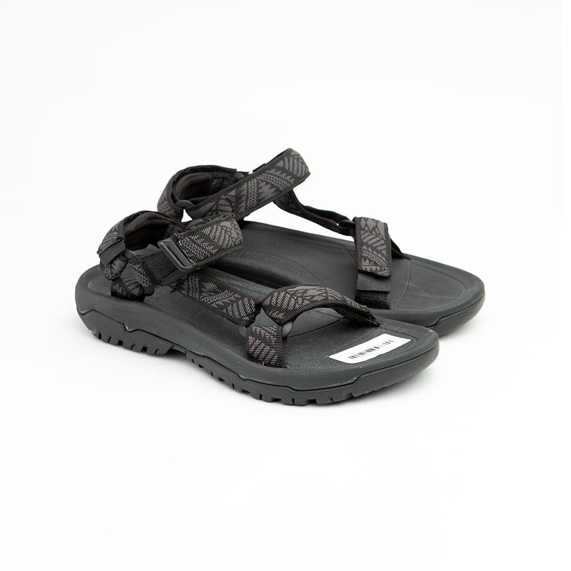 Black all-terrain unisex sport sandals with patterned adjustable straps and rugged rubber sole.