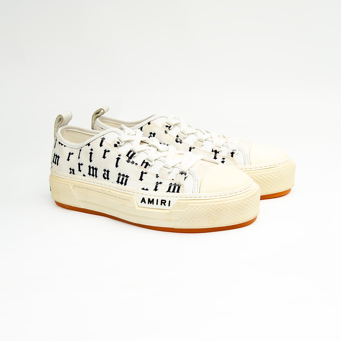These statement sneakers capture the brand's signature rock-and-roll aesthetic with an eye-catching all-over, black, gothic-style script print on a crisp white canvas upper.