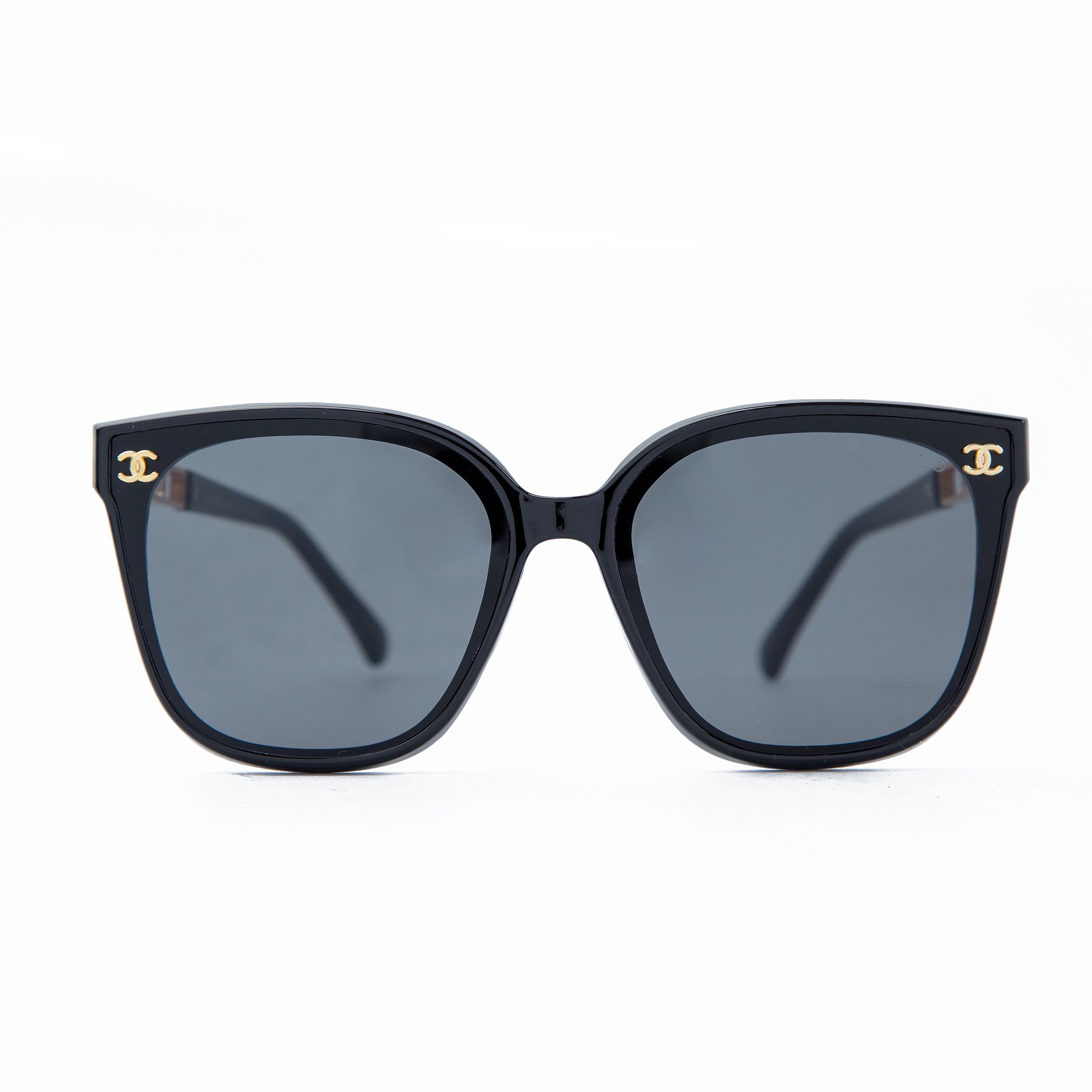 Elegant Chanel black cat-eye sunglasses with gold side detailing. Stylish eyewear offering UV protection, timeless design, and luxurious craftsmanship.