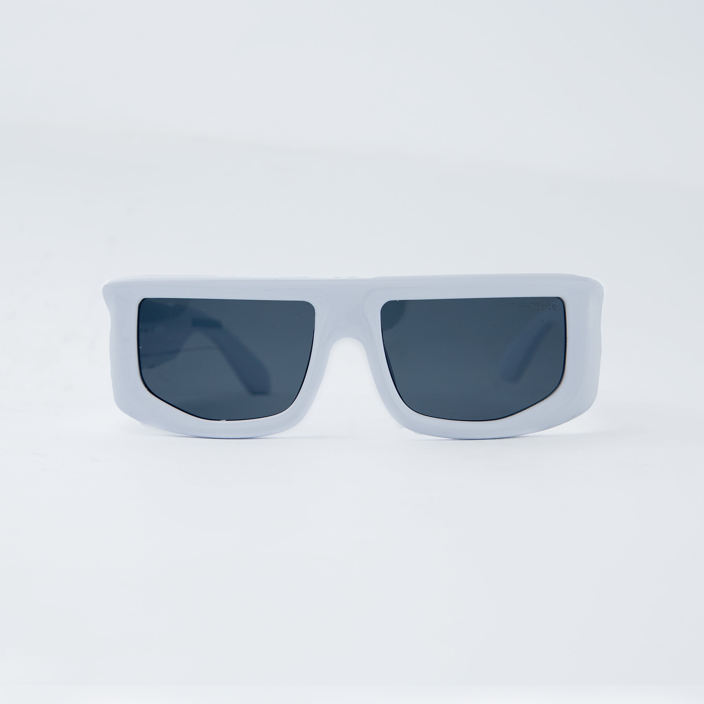 Off-White rectangular white sunglasses with black-tinted lenses, featuring a bold and modern design. Unisex eyewear for a stylish and contemporary look.