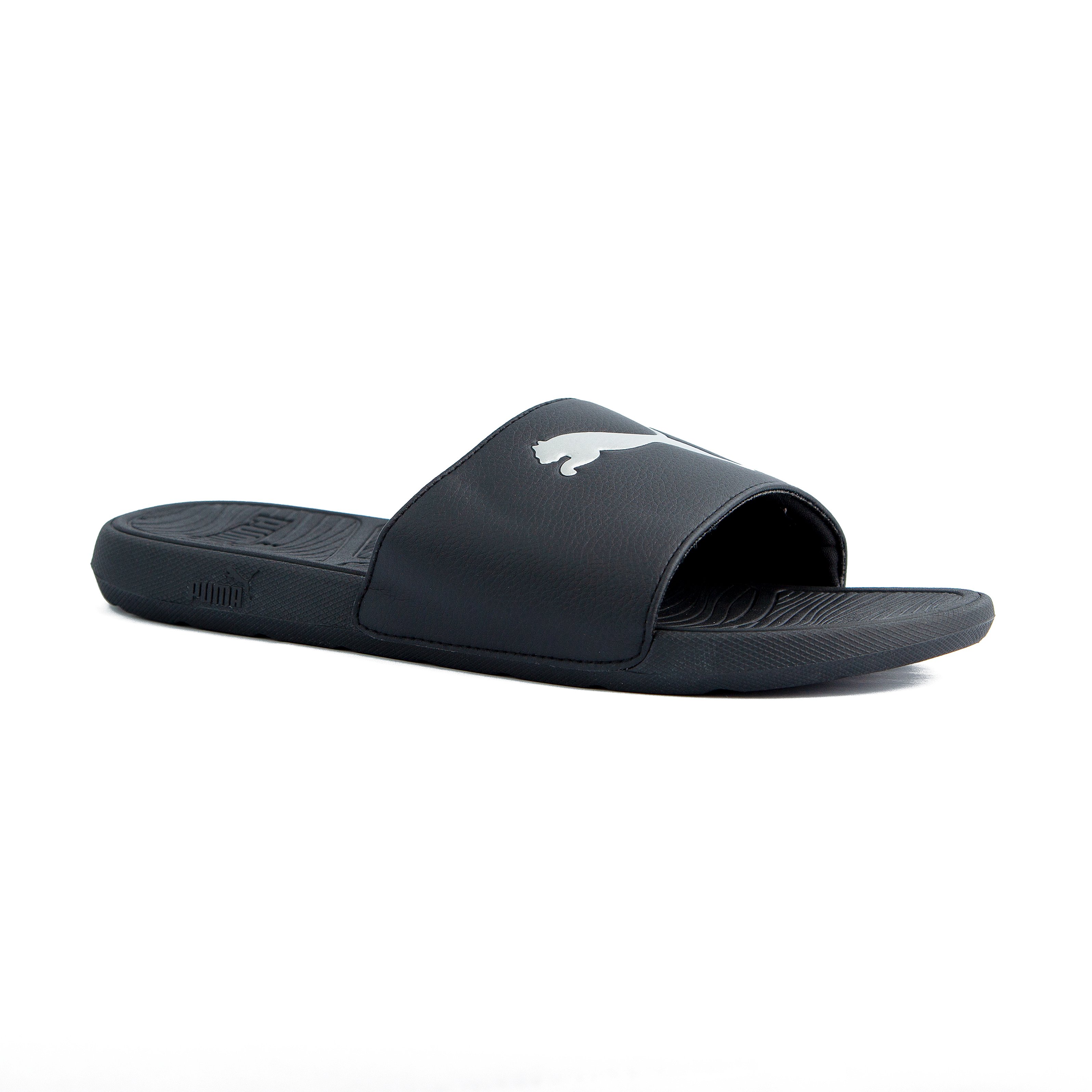 Black Puma slide sandals with white logo, unisex design, durable strap, and comfortable textured footbed for casual wear and relaxation.