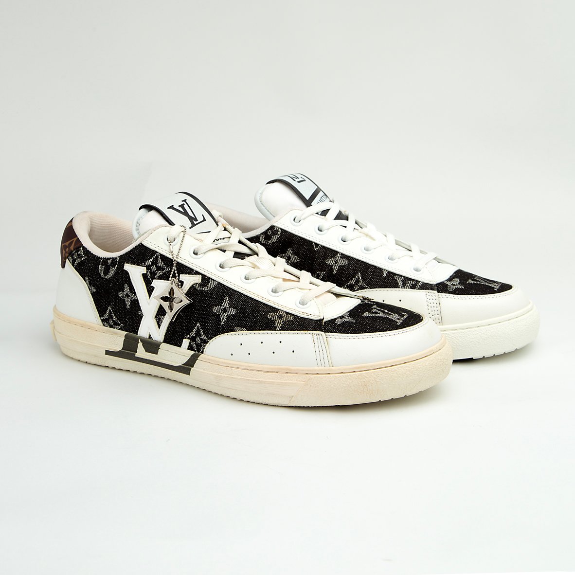 The LV Trainer Sneaker is a luxury low-top sneaker that blends high-fashion craftsmanship with a retro basketball and skate shoe aesthetic.