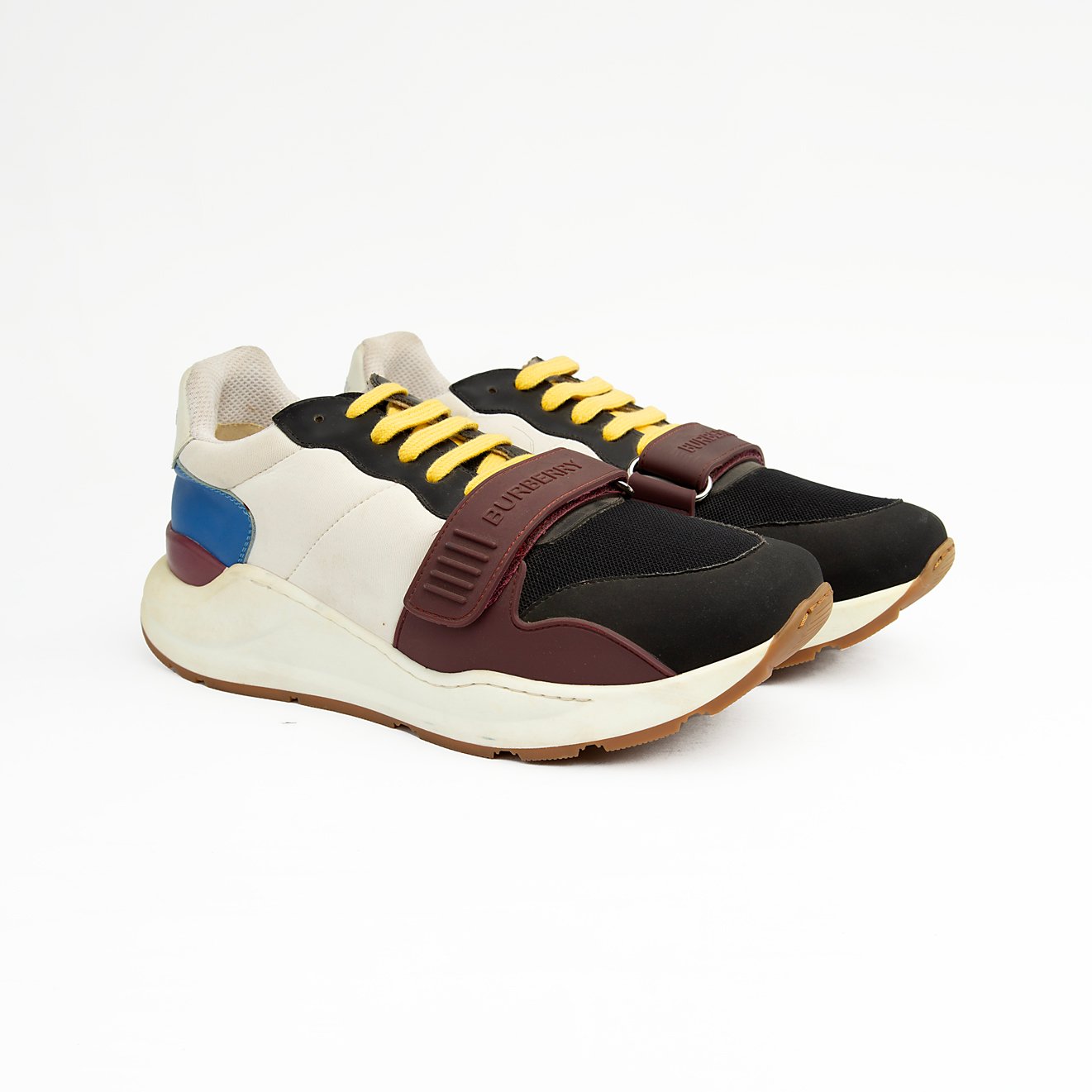 Stylish unisex multi-tone sneakers with adjustable strap, yellow laces, and cushioned sole — perfect for casual and streetwear looks.