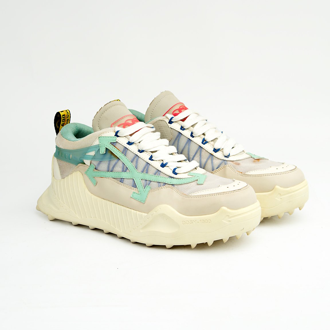 Chunky cream and mint green unisex mesh sneakers with rugged soles and gradient side detail for a sporty modern look.
