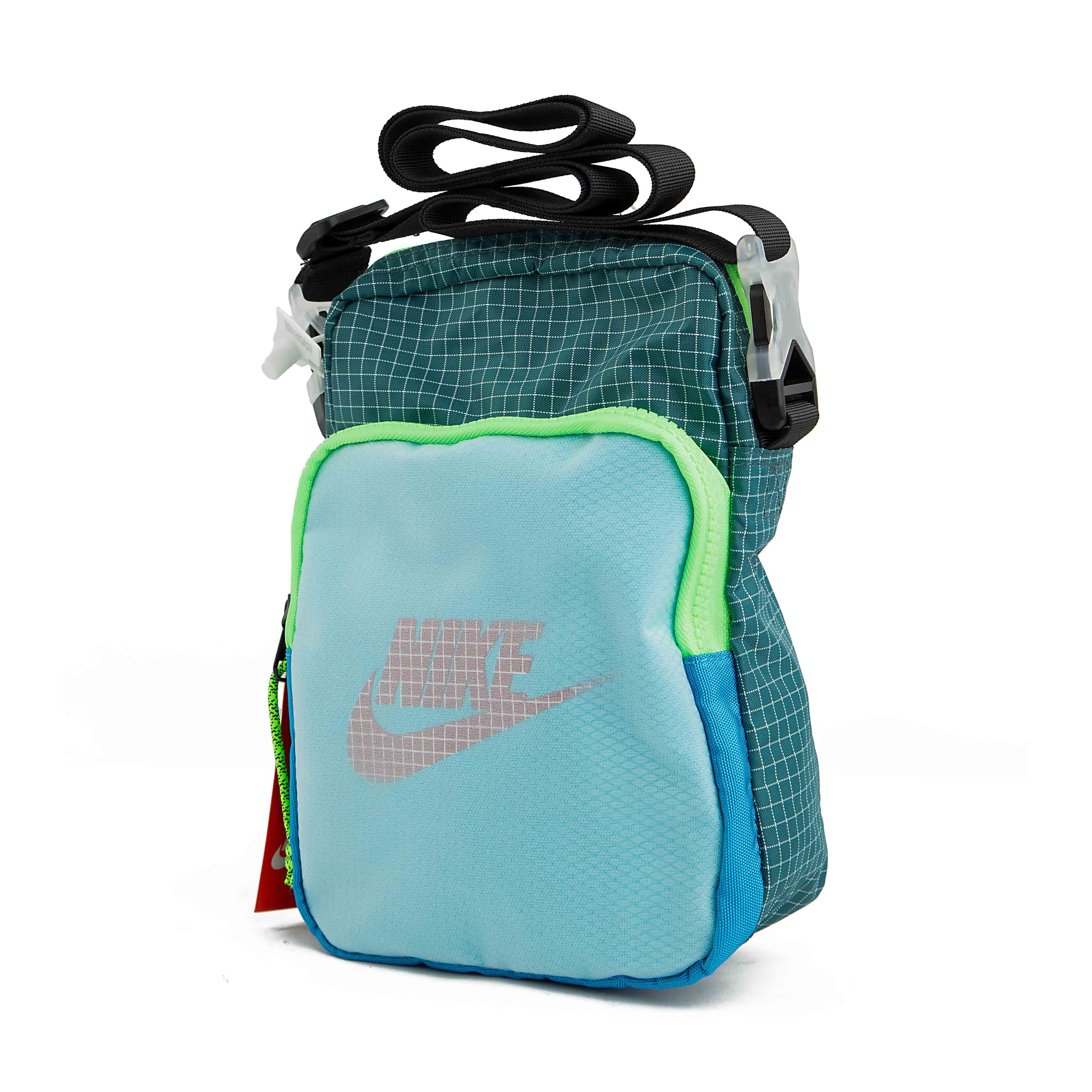 Carry your essentials in style with this unique teal grid-patterned shoulder bag.