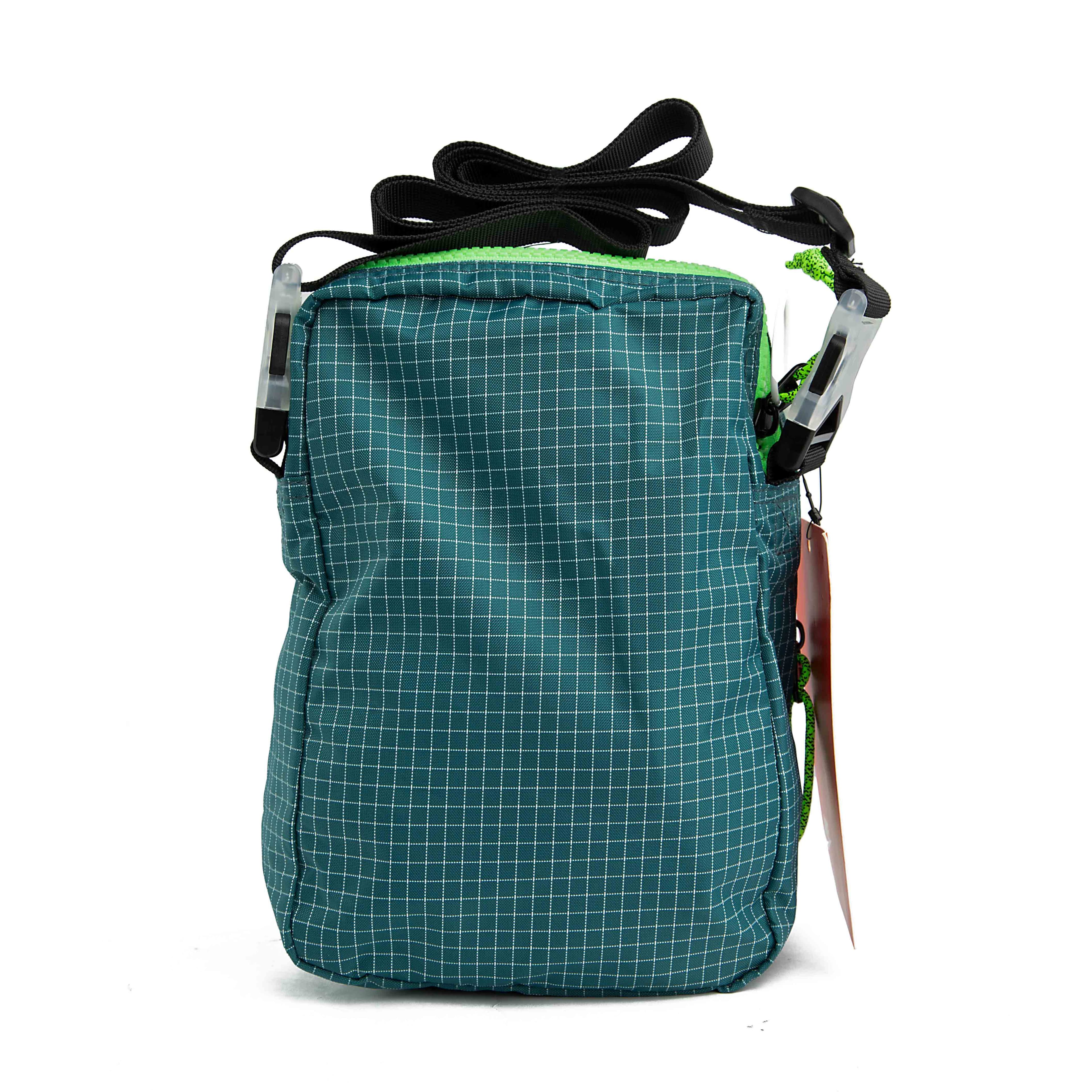 Carry your essentials in style with this unique teal grid-patterned shoulder bag.