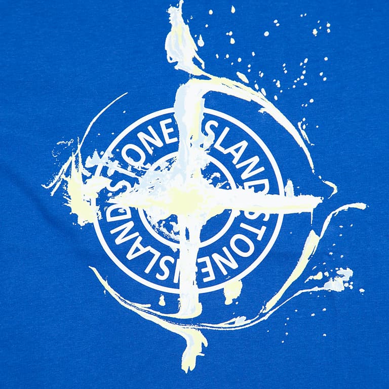 Royal Blue Stone Island T-Shirt featuring the iconic Compass logo with a distressed splash graphic. Premium cotton, essential designer streetwear