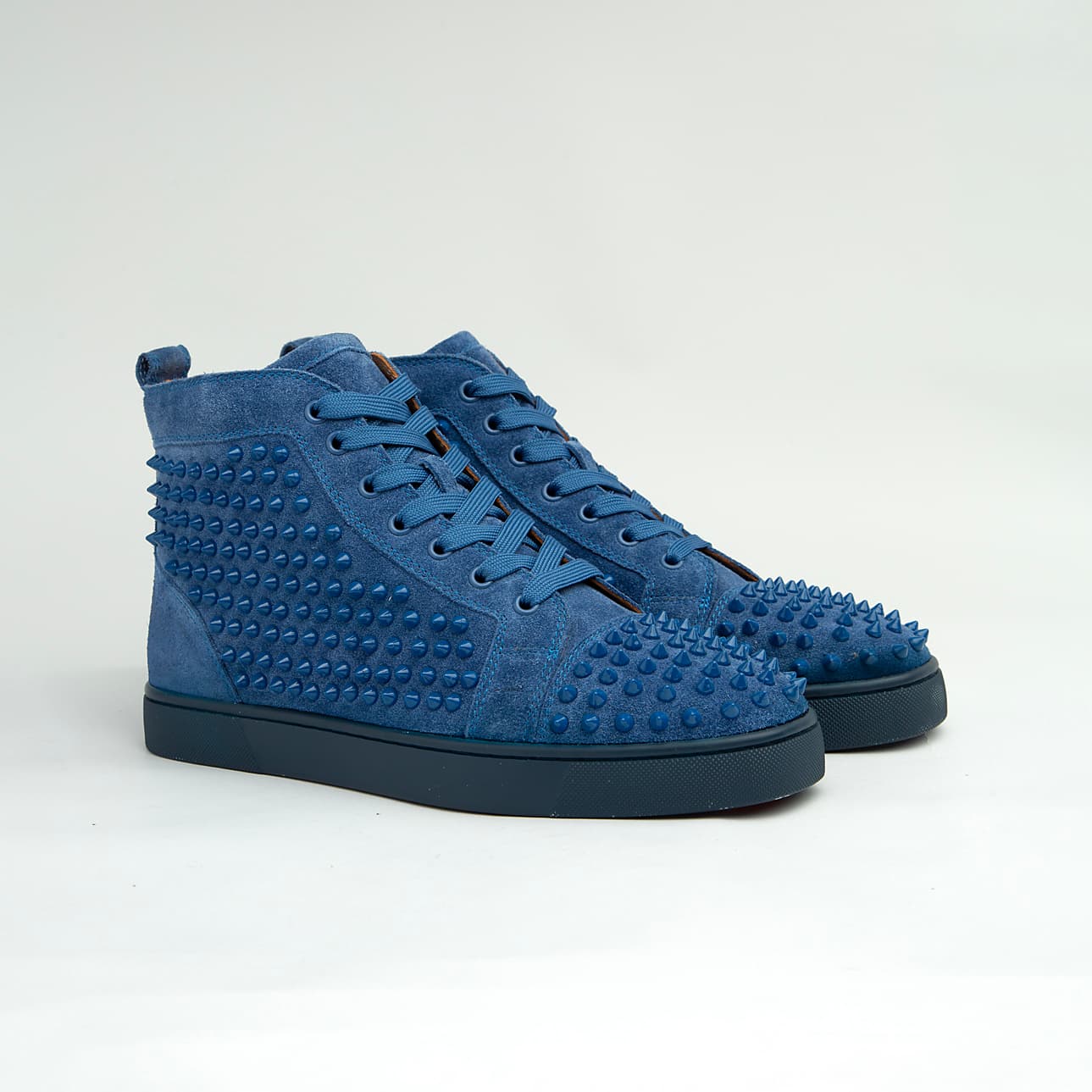 The Cobalt Studded Street is a defiant, high-top luxury sneaker designed for maximum statement impact.
