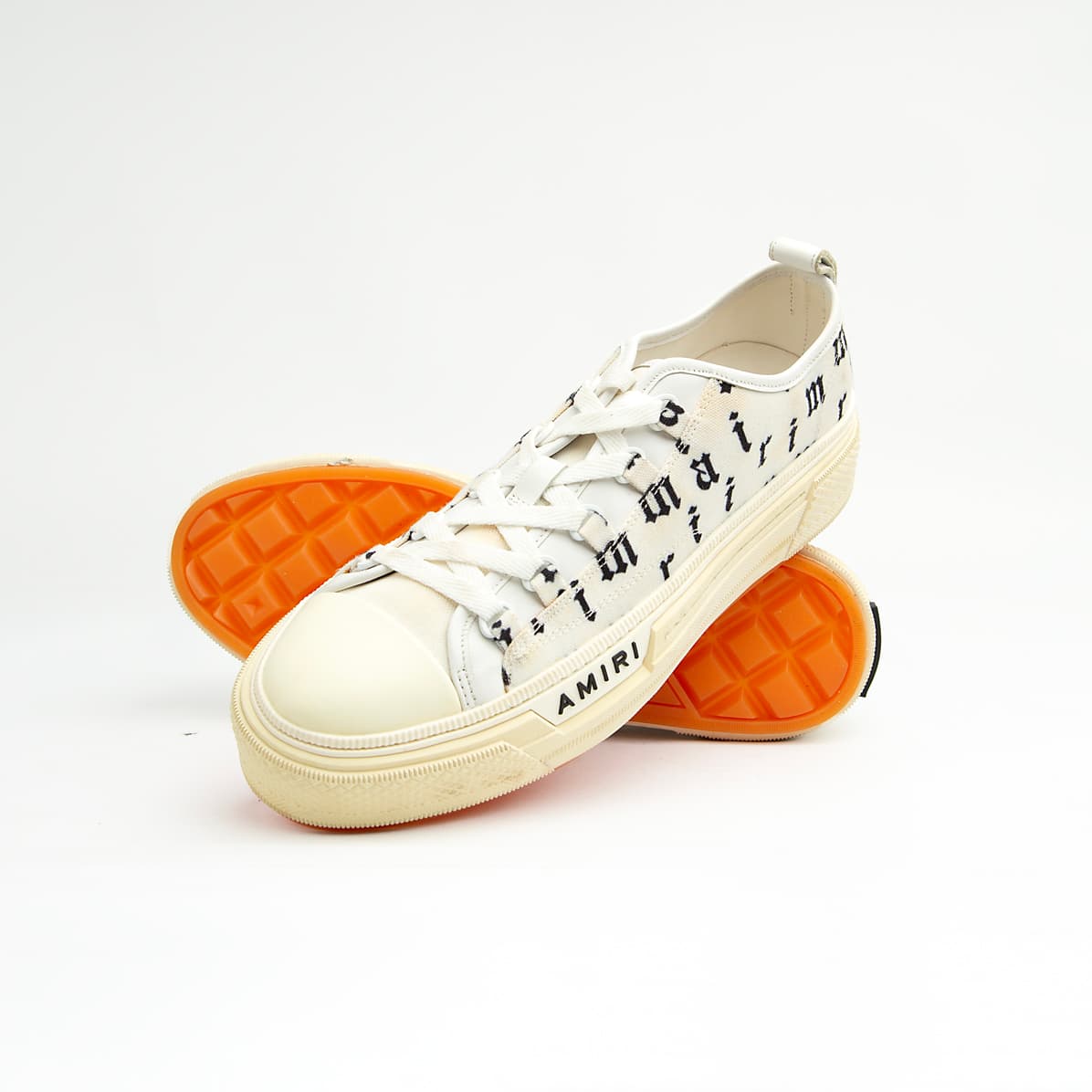 These statement sneakers capture the brand's signature rock-and-roll aesthetic with an eye-catching all-over, black, gothic-style script print on a crisp white canvas upper.